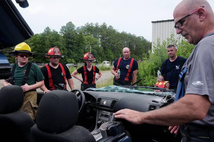 Ascutney Fire Chief Darrin Spaulding, right, speaks to his firefighters about the structure and safety features of a Subaru after they practiced removing the roof to simulate the removal of a patient for training at Hodgdon Brothers salvage yard in Ascutney, Vt., on Tuesday, June 29, 2021. Spaulding, who is also a forest fire warden for the Town of Weathersfield, said the volunteer fire department has fought one brush fire in town this year, but has served as mutual aid for several others. (Valley News - James M. Patterson) Copyright Valley News. May not be reprinted or used online without permission. Send requests to permission@vnews.com.