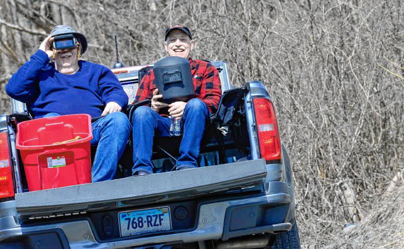 Dave Bossier of Granby, Conn. and Quentin Roohr, of East Granby, Conn., pull off to the side of the road on Route 5 in Putney, Vt., to view the 96 percent partial solar eclipse on Monday, April 8, 2024. They were trying to make it to totality but with traffic decided to pull off in Putney. (Kristopher Radder/The Brattleboro Reformer via AP)