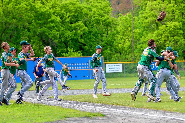 White River Valley High baseball players, including catcher Brayden Russ (19), celebrate their 1-0 defeat of visiting Windsor on June 5, 2023, in the Vermont Division III quarterfinals in South Royalton, Vt. (Valley News - Tris Wykes) Copyright Valley News. May not be reprinted or used online without permission. Send requests to permission@vnews.com.