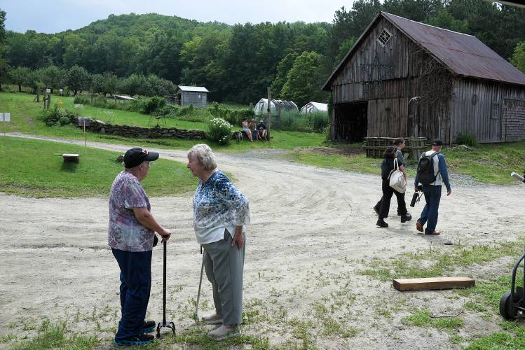 Sylvia Fitch, left, talks with Sally Mansfield Smith, right, as guests and members of the extedned Fitch Family tour the 250-year-old homestead in Cornish, N.H., during a celebration of the anniversary of the farm's 1771 deed on Saturday, July 29, 2023. The celebration had been planned for the summer of 2021, but was postponed because of the COVID-19 pandemic and Fitch's husband, Howard, died just two weeks shy of being able to attend. Mansfield Smith is a niece of Grace Fitch, who lived at the farm. (Valley News - James M. Patterson) Copyright Valley News. May not be reprinted or used online without permission. Send requests to permission@vnews.com.