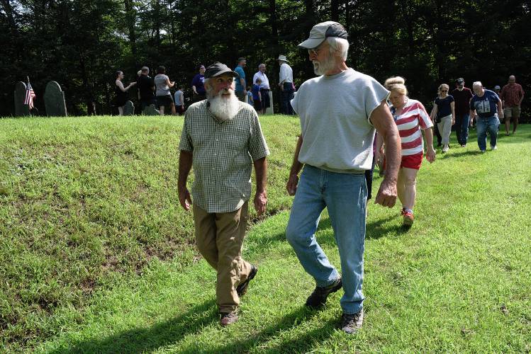 Jim Fitch, left, talks with Jerry Eastman, right, while leading a tour of Fitch family graves at the Chase Cemetery as part of the 250th anniversary celebration of the Fitch family farm in Cornish, N.H., on Saturday, July 29, 2023. Eastman said an ancestor of his served with members of the Fitch family in the Revolutionary War. (Valley News - James M. Patterson) Copyright Valley News. May not be reprinted or used online without permission. Send requests to permission@vnews.com.