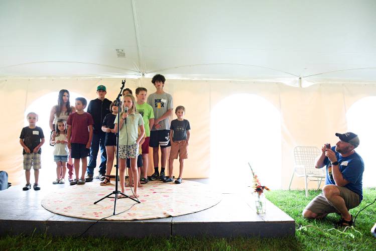 Gabe Zoerheide, of Strafford, takes video as his daughter Nell, 8, sings a song in Cornish, N.H., on Saturday, July 29, 2023, surrounded by fellow 10th generation extended Fitch family members during a celebration of the 250th anniversary of the farm settled by their ancestor Hezekiah Fitch in 1771. (Valley News - James M. Patterson) Copyright Valley News. May not be reprinted or used online without permission. Send requests to permission@vnews.com.