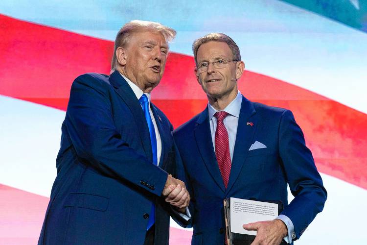 Former President Donald Trump shake hands with Family Research Council President Tony Perkins before he speaks at the Pray Vote Stand Summit, Friday, Sept. 15, 2023,, in Washington.(AP Photo/Jose Luis Magana)