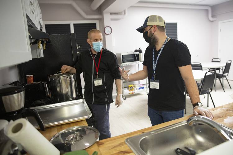 Volunteer Michael Arnold, left, and Matt Pickell, Upper Valley Haven volunteer coordinator, prepare for dinner service at the Lebanon Emergency Winter Shelter in Lebanon, N.H., on Thursday, Jan. 25, 2024. Dinner will be available for shelter guests every night, with Listen Community Services providing meals during the week and Alice Peck Day Memorial Hospital providing meals on weekends. (Valley News / Report For America - Alex Driehaus) Copyright Valley News. May not be reprinted or used online without permission. Send requests to permission@vnews.com.