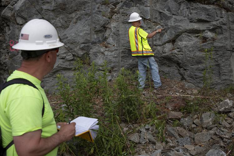 Dave Scarpato, left, president of Scarp Tec, and Jay Smerekanicz, senior engineering geologist, measure variations in the rock face along I-91 in order to design a new protective mesh in Fairlee, Vt., on Wednesday, July 3, 2024. The new mesh will be installed in 2025, replacing the current mesh drape that was put up in 1996. (Valley News - Alex Driehaus) Copyright Valley News. May not be reprinted or used online without permission. Send requests to permission@vnews.com.