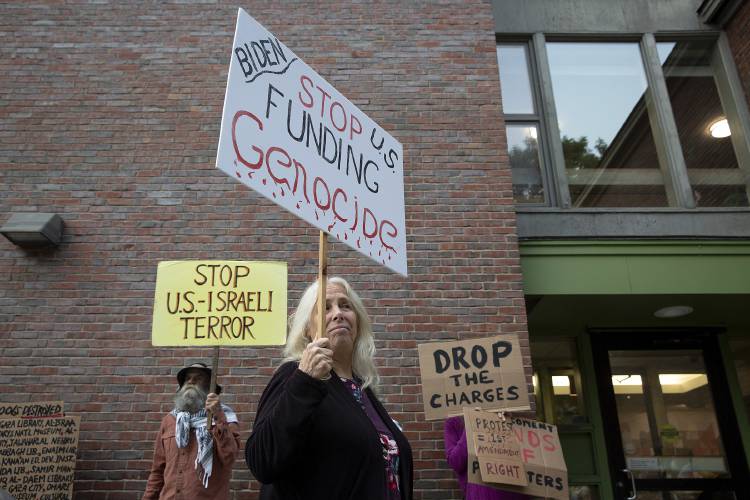 June Goodband, center, of Springfield, Vt., a Vermont gubernatorial candidate for the Green Mountain Peace and Justice Party, participates in an Upper Valley for Palestine protest before a listening session held by the Hanover Selectboard at the Howe Library in Hanover, N.H., on Tuesday, Aug. 20, 2024. Members of the group were critical of the Selectboard’s decision to hold the event when most students, including those who were arrested on May 1, are not on campus, and took issue with the format of the session, which did not allow the opportunity for members of the public to directly ask questions of the police chief or receive answers from the Selectboard. (Valley News - Alex Driehaus) Copyright Valley News. May not be reprinted or used online without permission. Send requests to permission@vnews.com.