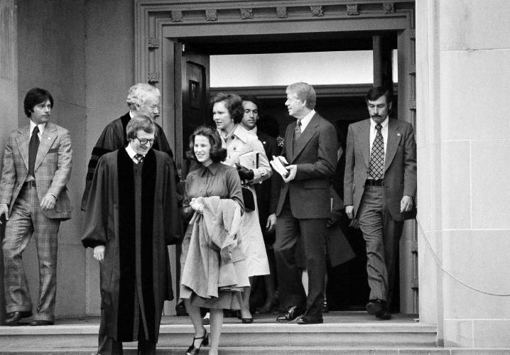 FILE - President Jimmy Carter and Rosalynn Carter chat with Rev. Charles Trentham as they leave the First Baptist Church in Washington on March 20, 1977. (AP Photo/Charles W. Harrity, File)