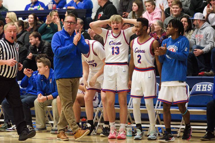 Hartford coach Mike Gaudette, left, and players Noah Danielli (13), Evan Lynds (2), and Ayodele Lowe (12) react to a rapid series of baskets made by the Hurricanes in the second quarter against Windsor in White River Junction, Vt., on Friday, Feb. 2, 2024. Hartford won 68-16. (Valley News - James M. Patterson) Copyright Valley News. May not be reprinted or used online without permission. Send requests to permission@vnews.com.