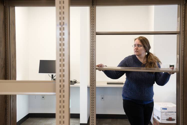 Library clerk Jerusha Howard assebles shelving in the 2,040 square foot addition to the Enfield Public Library at Whitney Hall in Enfield, N.H., on Tuesday, Jan. 21, 2025. Library staff began the move back into their new space on Jan. 13 and hope to be open in early February. (Valley News - James M. Patterson) 