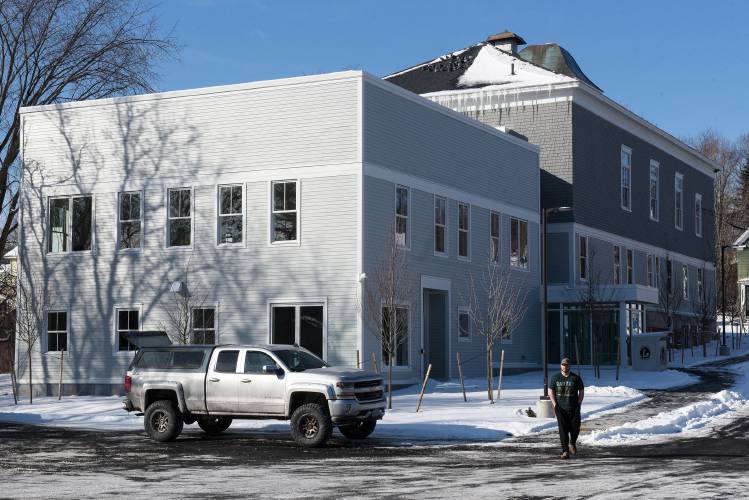 Matt Ocker departs from Whitney Hall after dropping off breakfast for his wife, who works in the Enfield, N.H. Town Clerk's office, and getting a tour of the renovations and addition to the building on Tuesday, Jan. 21, 2025. The addition expands the second floor library space by nearly 70% to a total 4,985 square feet with town offices on the ground floor. (Valley News - James M. Patterson) 