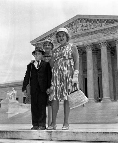 Madalyn E. Murray of Baltimore, Md., right, poses with one of her sons, Garth, 8, and her mother, Bonna Mays, outside the Supreme Court building in Washington, D.C., June 17, 1963. The court ruled 8-1 that it is unconstitutional for a state to require Bible reading and recitation of the Lord's prayer in public schools. Murray and her 16-year-old son attending high school had challenged constitutionality of a Baltimore city school board regulation. (AP Photo)