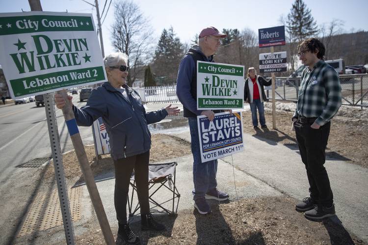 From left, Rosemary Affeldt, of West Lebanon, N.H., and Paul McDonough, of Lebanon, N.H., talk to City Council ward two candidate Devin Wilkie during ballot voting at the United Methodist Church in Lebanon, N.H., on Tuesday, March 11, 2025. Wilkie, the incumbent candidate, ran against Paul Roberts in a contested race. (Valley News - Alex Driehaus)

