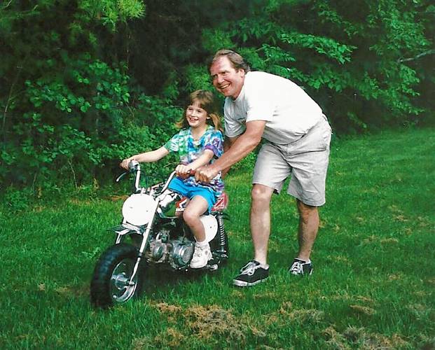 Jimmy Proctor guides his niece Andrea on a Z50 motorcycle in an undated photograph. If she twisted the throttle, he would lift up the rear wheel. (Family photograph)