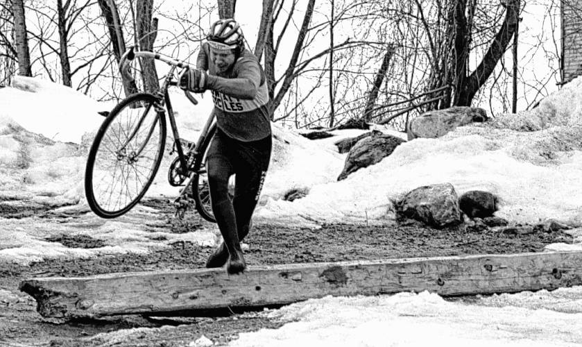 When Jimmy Proctor goes out for a bicycle ride, he does his share of walking and carrying as well, during practice for cycle-cross competitions on March 25, 1986. (Valley News - Dan Hunting)