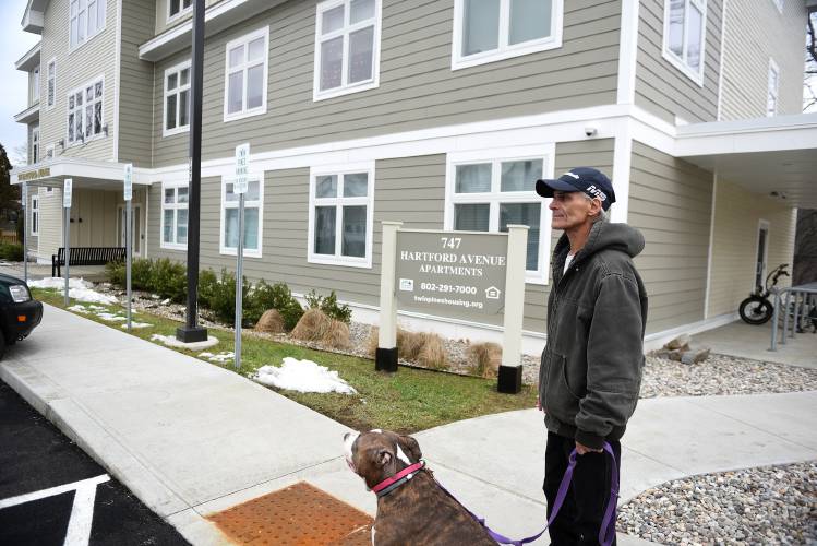 After taking his dog Angel for a walk, Freddy Bailey heads back to his apartment in White River Junction, Vt., on Thursday, Dec. 19, 2024. Bailey moved into his apartment in October. Developed by Twin Pines Housing, the 18 one-bedroom units are located on St. Paul’s Episcopal Church property, adjacent to the Upper Valley Haven. (Valley News-Jennifer Hauck)