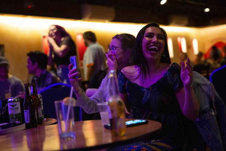 Caroline Koziol, left, and Izzy Diaz, both of Hanover, N.H., react while listening to Allison Hewitt, of North Sutton, N.H., not pictured, perform during karaoke night at Sawtooth Kitchen, Bar and Stage in Hanover, N.H., on Tuesday, Aug. 13, 2024. Diaz, Sawtooth’s head bartender, said that karaoke has been a great addition to the bar’s regular events. “The community that we’ve built is just stellar,” she said. (Valley News - Alex Driehaus) Copyright Valley News. May not be reprinted or used online without permission. Send requests to permission@vnews.com.