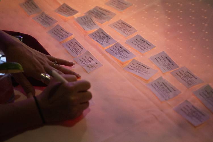 Amy Alexander, co-owner of Events AS Planned and karaoke DJ, makes notes on song request cards during karaoke night at Sawtooth Kitchen, Bar and Stage in Hanover, N.H., on Tuesday, Aug. 13, 2024. Alexander said the karaoke night at Sawtooth has established a dedicated group of regulars who are welcoming and supportive of one another. (Valley News - Alex Driehaus) Copyright Valley News. May not be reprinted or used online without permission. Send requests to permission@vnews.com.