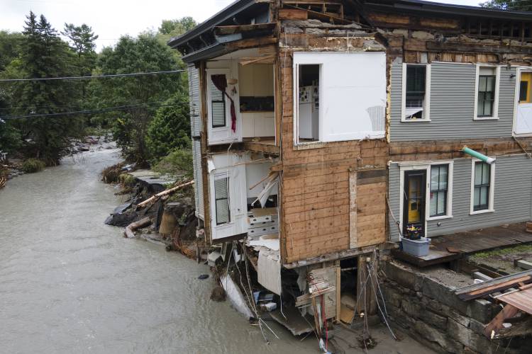 FILE - The remains of an eight unit apartment building that locals call the Heartbreak Hotel are in Plainfield, Vermont, on July 12, 2024, after flood waters and debris caused by the aftermath of Hurricane Beryl pulled several of the apartments into the Great Brook waterway. Vermont is seeking a federal assessment to determine whether last week’s flooding, which damaged homes, knocked out bridges and washed out roads, qualifies for a federal disaster declaration and aid. (AP...