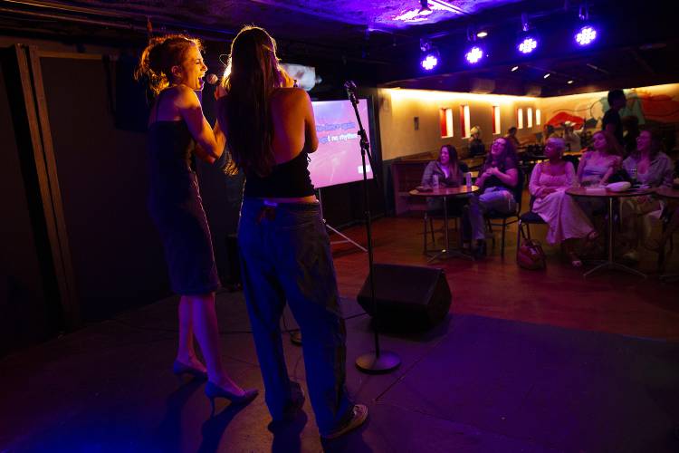 Carlin Martinez, left, sings with her daughter Galadriel Martinez, both of Quechee, Vt., during karaoke night at Sawtooth Kitchen, Bar and Stage in Hanover, N.H., on Tuesday, Aug. 13, 2024. (Valley News - Alex Driehaus) Copyright Valley News. May not be reprinted or used online without permission. Send requests to permission@vnews.com.