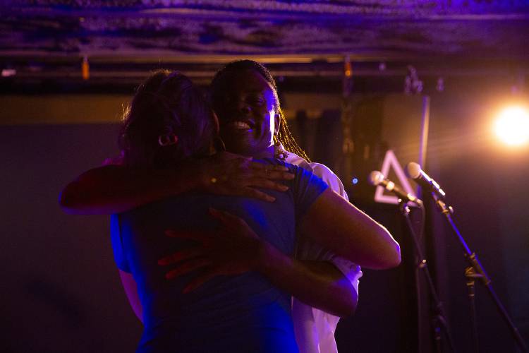 Francois LeSage, right, of Hanover, N.H., hugs DJ Amy Alexander after performing during karaoke night at Sawtooth Kitchen, Bar and Stage in Hanover, N.H., on Tuesday, Aug. 13, 2024. LeSage, a regular at karaoke night, had just returned from an overseas trip and after dropping off their bags at home decided to stop by for “one song and one drink,” they said. (Valley News - Alex Driehaus) Copyright Valley News. May not be reprinted or used online without permission. Send requests to permission@vnews.com.