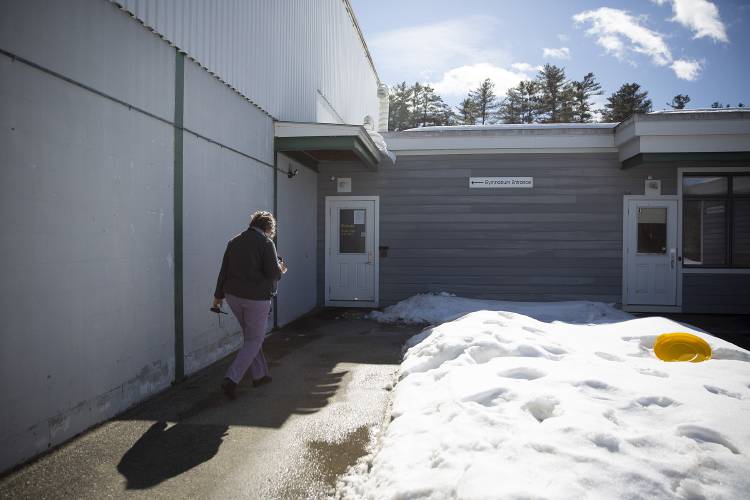 Principal Audra Bucklin walks toward the gymnasium entrance at Plainfield Elementary School in Meriden, N.H., on Friday, Feb. 28, 2025. The proposal to renovate the school building includes adding a new 440 square-foot entryway that would serve as a middle school entrance and allow ADA-compliant access to the gymnasium. (Valley News - Alex Driehaus)