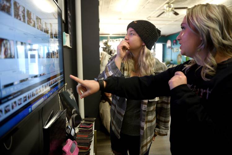 Jess Kinson, owner of Les Bella Boudoir, left, helps client Shelby Soulia with an edit of her photographs following Soulia's session at the studio in Claremont, N.H., on Tuesday, Jan. 9, 2024. (Valley News - Jennifer Hauck) Copyright Valley News. May not be reprinted or used online without permission. Send requests to permission@vnews.com.