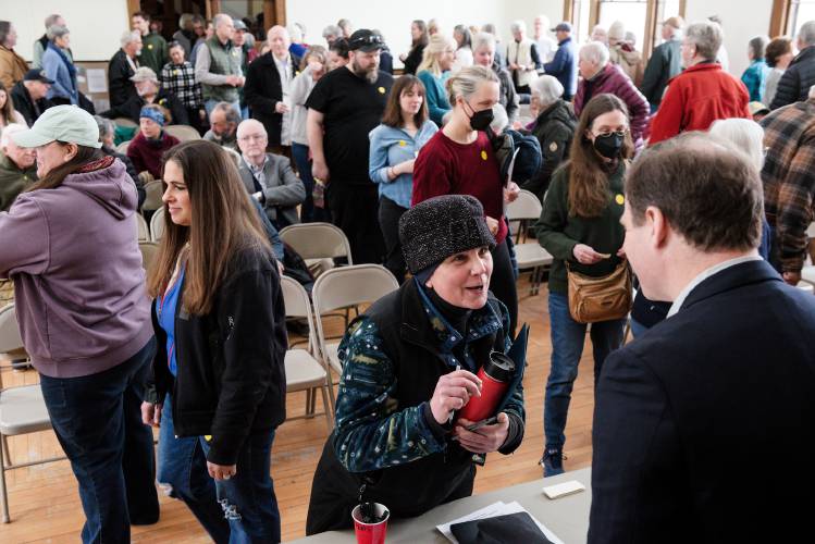 Jill Delaney talks with West Windsor Selectboard Chair Mark Higgins after casting her vote against repealing the town's short-term rental ordinance at Town Meeting in Brownsville, Vt., on Tuesday, March 4, 2025. Delaney, the owner of Delaney Stables, said she has needed to call police and remove signage for her business because of uninvited visitors wandering her property and taking pictures on her tractor. She said the encounters have forced her to alter the way she greets and interacts with guests. (Valley News - James M. Patterson) Copyright Valley News. May not be reprinted or used online without permission. Send requests to permission@vnews.com.