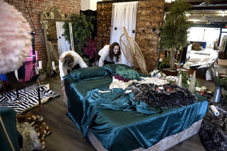 Les Bella Boudoir owner Jess Kinson, left, and associate photographer Sarah McEnany change one of the studio's sets on Tuesday, Dec. 5, 2023, in Claremont, N.H. Kinson and McEnany often create new scenes at the studio for their clients to be photographed in. (Valley News - Jennifer Hauck) Copyright Valley News. May not be reprinted or used online without permission. Send requests to permission@vnews.com.