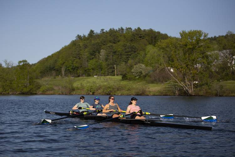 From front, Caroline Horak, 17, Anna Numme, 18, Georgia Gaffney, 14, and Owen Robb, 17, row down the Connecticut River with the guidance of coxswain Elizabeth Canaverel, 17, during crew practice with the Upper Valley Rowing Foundation in Hanover, N.H., on Thursday, May 18, 2023. (Valley News / Report For America - Alex Driehaus) Copyright Valley News. May not be reprinted or used online without permission. Send requests to permission@vnews.com.