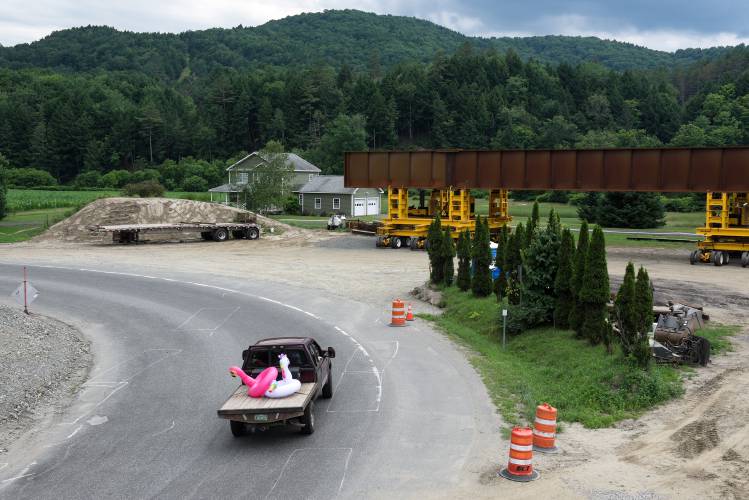 A truck heads toward the White River after passing under a railroad underpass on Route 14 in Royalton, Vt., on Friday, July 5, 2024, that will be replaced with a new bridge, at right, during a 21-day closure beginning Tuesday. The long span will provide space for a realignment of the road with traffic in both directions. (Valley News - James M. Patterson) Copyright Valley News. May not be reprinted or used online without permission. Send requests to permission@vnews.com.