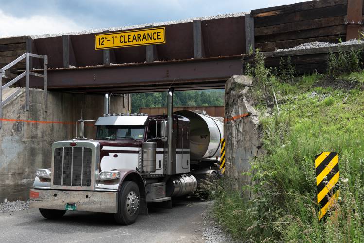 An antenna on tanker truck bounces back after scraping under the New England Central Railroad overpass on Route 14 in Royalton, Vt., on July 5, 2024. The 21 foot span built in 1908, will be replaced with a bridge that increases the clearance by two feet during a 21 day road closure beginning on Tuesday, July 9. The railroad will also close for round-the-clock work between July 11 and July 16. (Valley News - James M. Patterson) Copyright Valley News. May not be reprinted or used online without permission. Send requests to permission@vnews.com.