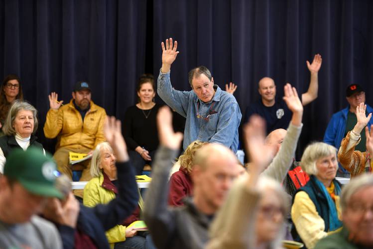 At the end of Lyme’s Town Meeting in Lyme, N.H., on March 11, 2025, residents are asked by Town Moderator Mark Schiffman about their interest in moving the annual meeting to a different time or day. A petitioned warrant article asked the question if voters would grant the selectboard the ability to change the time and day of the meeting.(Valley News-Jennifer Hauck)