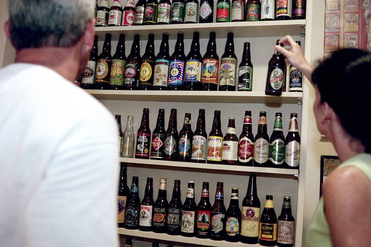 Customers look at a variety of beers on display at the Catamount Brewery store in Windsor, Vt., on July 2, 1999. Harpoon Brewery of Boston is close to buying the bankrupt brewery, according to a Windsor official in June 2000. (Valley News - Amy Thompson)