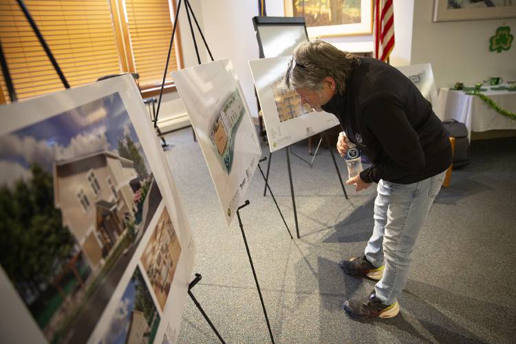 Philip Sargent, of Wilder, Vt., takes a close look at renderings of the Upper Valley Haven’s new shelter and resource center during a community meeting on the project held at the Bugbee Senior Center in White River Junction, Vt., on Thursday, March 13, 2025. “I like to see where my tax money is going,” said Sargent, who said he supports the project. (Valley News - Alex Driehaus)