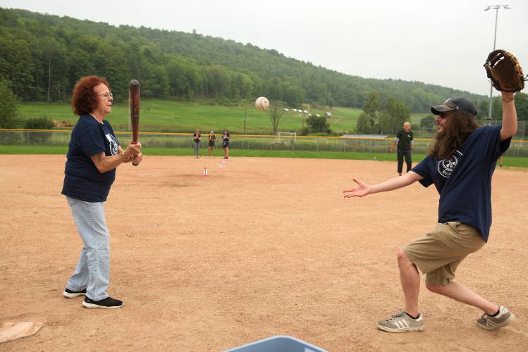 Bugbee Senior Center Administrator Alek Struver, right, pitches to Martha Dupuis, 72, of Wilder, left, during the Bugbee Summer Games home run derby at Maxfield Sports Complex in Hartford, Vt., on Friday, Aug. 16, 2024. It is the week-long event's inaugural year with 14 planned events and 65 participants from roughly 20 towns. (Valley News - James M. Patterson) Copyright Valley News. May not be reprinted or used online without permission. Send requests to permission@vnews.com.