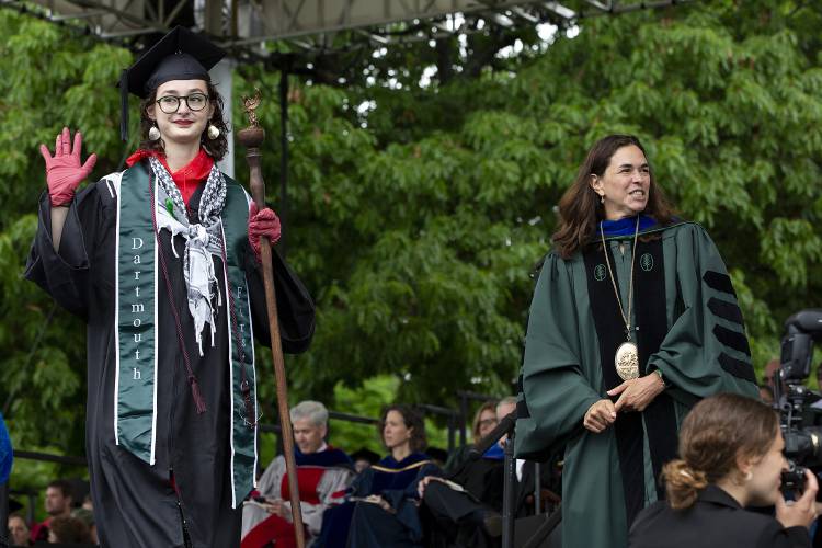 Abigail Bordelon holds up a red-gloved hand after opting not to shake hands with Dartmouth President Sian Leah Beilock while walking across the stage during the Dartmouth College commencement ceremony on the green in Hanover, N.H., on Sunday, June 9, 2024. Several students, many wearing keffiyehs or other pro-Palestinian adornments, declined to shake hands with Beilock. (Valley News - Alex Driehaus) Copyright Valley News. May not be reprinted or used online without permission. Send requests to permission@vnews.com.
