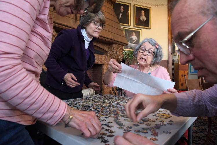 Diane McConnon, of Wells River, right, and Betsy Nadeau, of Bradford, left, refer to a picture of Charles Wysocki's 