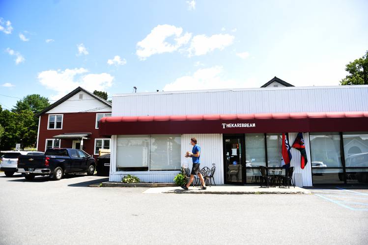 Cole Dunbar, of West Lebanon, N.H. leaves the The Karibbean with takeout food on Friday, July 26, 2024 in West Lebanon. Dunbar has recently moved to the area and said he was 