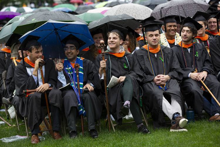 Graduates attempt to stay dry in the rain during the Dartmouth College commencement ceremony on the green in Hanover, N.H., on Sunday, June 9, 2024. (Valley News - Alex Driehaus) Copyright Valley News. May not be reprinted or used online without permission. Send requests to permission@vnews.com.