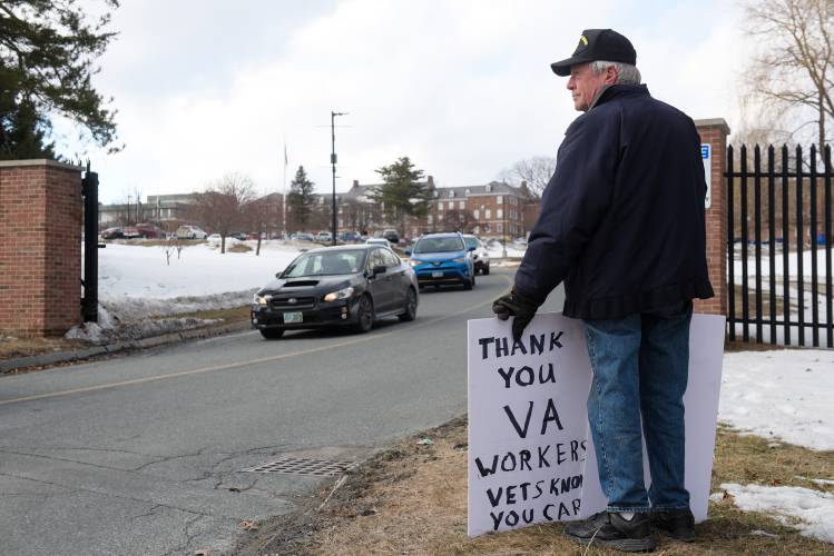 Army veteran Jake Guest, of Thetford, shows his appreciation for workers at the White River Junction, Vt., VA Medical Center in the face of cuts to personnel from the Trump Administration on Friday, March 7, 2025. 