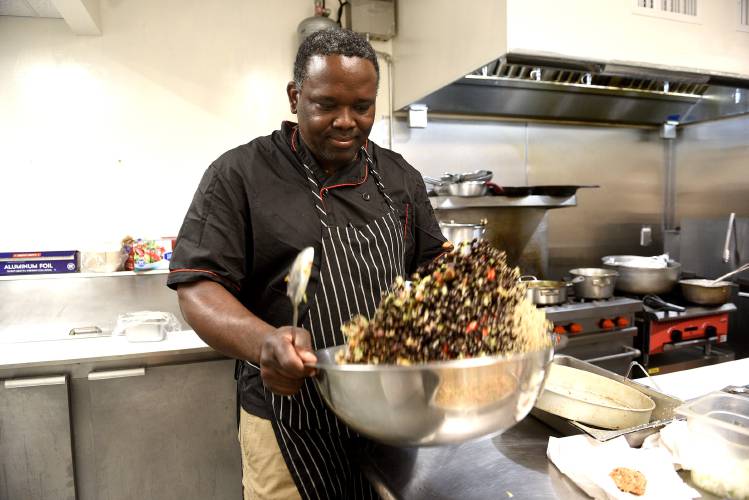 The Karibbean owner Balvin Bowen makes a quinoa salad at his newly-opened restaurant in West Lebanon, N.H., on Friday, July 26, 2024. Bowen also has a restaurant in Lebanon and sells food at the Lebanon, Norwich and Hartland farmers markets. (Valley News - Jennifer Hauck) Copyright Valley News. May not be reprinted or used online without permission. Send requests to permission@vnews.com.