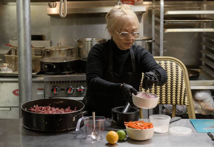 Mariella Cubillet prepares ropa vieja, Spanish for old clothes, a Cuban braised, shredded roast beef dish in the kitchen at Little Havana in Hanover, N.H., on Saturday, Dec. 14, 2024. Cubillet, her daughter Maylena Chaviano, son Ernesto Medina and family friend Yuniesky Miyar opened the restaurant featuring Cubilletâs Cuban home cooking on Dec. 3. (Valley News - James M. Patterson) 