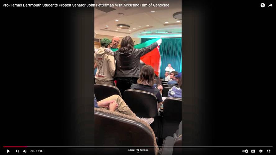 In a video posted to YouTube by Raul Hernandez, Greyson Xiao, a Dartmouth senior, and Emma Herndon, a service specialist in Dartmouth’s Office of the Registrar, are shown standing and holding up a Palestinian flag and chanting pro-Palestinian slogans during an appearance by U.S. Sen. John Fetterman at Dartmouth College in Hanover, N.H., on Oct. 23, 2024.