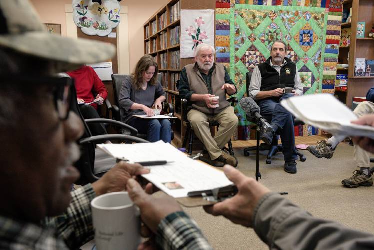 Sen. Dick McCormack, D-Windsor, of Bethel, 76, speaks as his constituents, Doug Marshall, front left, and Dave Eddy, front right, pass around ballot petitions the other members of the delegation at a legislative breakfast at the the Bethel (Vt.) Public Library, on Monday, May 13, 2024. Sen. Alison Clarkson, obscured at left, Sen. Becca White, left, and Rep. Kirk White, right, intend to run for reelection, while McCormack will not seek another term. (Valley News - James M. Patterson) Copyright Valley News. May not be reprinted or used online without permission. Send requests to permission@vnews.com.