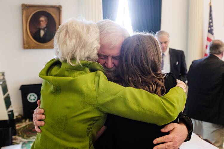Sen. Dick McCormack, D-Windsor, of Bethel, 76, hugs his fellow Windsor County Senators Alison Clarkson, left, and Becca White, right, after a resolution honoring his service was read on the floor of the Senate in Montpelier, Vt., on Friday, May 10, 2024. “I’m leaving the place in good hands,” said McCormack, of a younger generation of legislators like White, who he first met while teaching her U.S. history class at Community College of Vermont. (Valley News - James M. Patterson) Copyright Valley News. May not be reprinted or used online without permission. Send requests to permission@vnews.com.