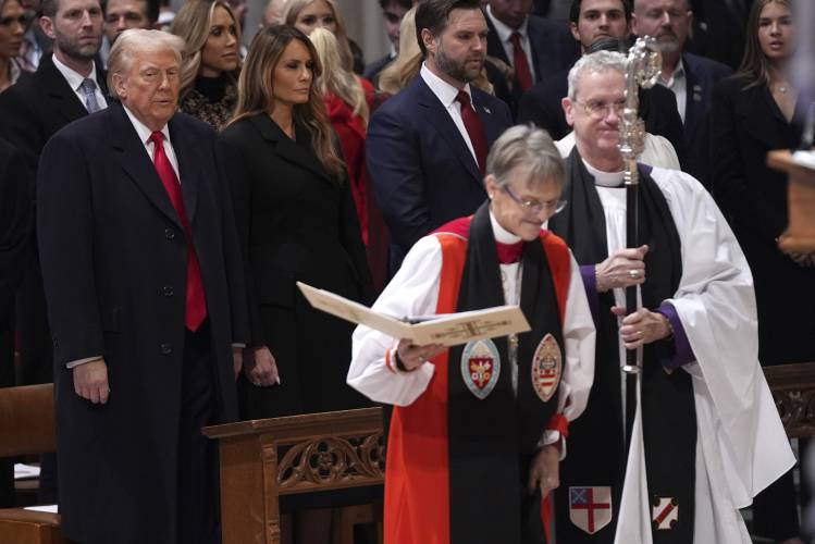 President Donald Trump, left, watches as Rev. Mariann Budde, second right, arrives at the national prayer service at the Washington National Cathedral, Tuesday, Jan. 21, 2025, in Washington. (AP Photo/Evan Vucci)