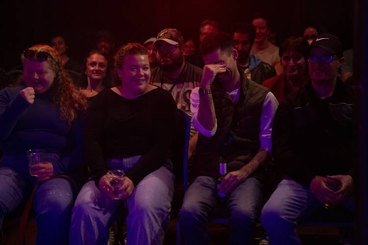 From left, Samantha Goveia, Rosalyn Goveia and Colin Sweeney, all of Lebanon, N.H., react as they listen to comics perform their five-minute sets during a comedy open mic event at Sawtooth Kitchen, Bar and Stage in Hanover, N.H., on Wednesday, Oct. 2, 2024. (Valley News - Alex Driehaus)