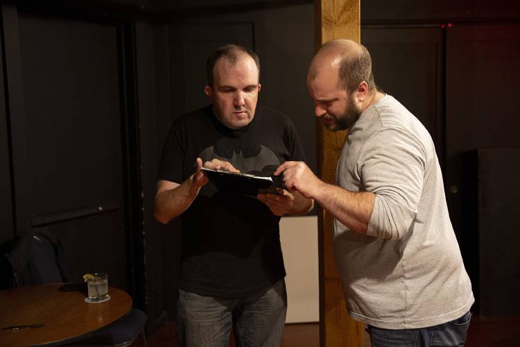 Kevin McTaggart, left, and Aaron Richter, look over the list of comics signed up to perform during a comedy open mic event at Sawtooth Kitchen, Bar and Stage in Hanover, N.H., on Wednesday, Oct. 2, 2024. (Valley News - Alex Driehaus)
