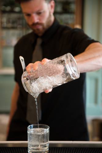 Casa Brava bar manager Austin Junker mixes a smoky quartz cocktail, named for the New Hampshire state gem at the restaurant in Hanover, N.H., on Saturday, Dec. 14, 2024. (Valley News - James M. Patterson) 