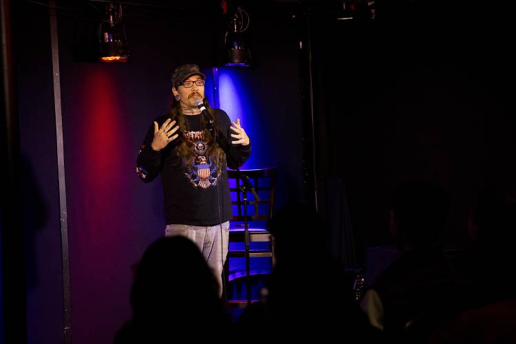 Robbie Partridge, of Loudon, N.H., performs a set about chaperoning his eight-grader’s school trip to Washington, D.C., during a comedy open mic event at Sawtooth Kitchen, Bar and Stage in Hanover, N.H., on Wednesday, Oct. 2, 2024. Open mics at Sawtooth have drawn comics from outside the Upper Valley who come to perform. (Valley News - Alex Driehaus)